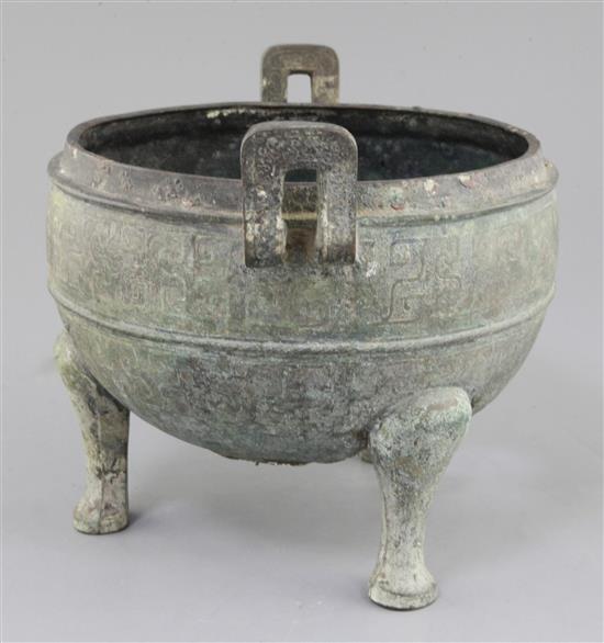 A Chinese archaic bronze tripod ritual food vessel, Ding, Eastern Zhou dynasty, 26.5cm wide, holes to base, cover lacking